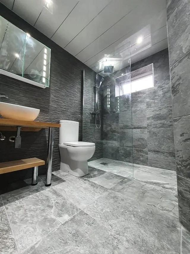 Stone Slate porcelain as a full feature wall combining with our 60 x 40 grey porcelain Stone Slate porcelain as a full feature wall combining with our 60 x 40 grey porcelain on the remaining walls and flooron the remaining walls and floor